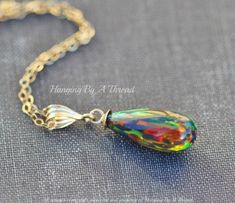 "A stunning new pendant made using created opal gemstone. The opals are a unique, elongated teardrop shape. They are capped with 14K gold filled, and hang from a 14K gold filled bail. Pendant measures 1 1/8\" tall (including bail) and opal alone is roughly 3/4\" tall. The opals are unique in that most have a vertical fire pattern. Pendant hangs from 14K gold filled chain in length of choice. Please choose desired chain length at checkout. Shown in gold filled in all images above. Please choose gold filled or sterling silver at checkout.  ** Matching earrings: https://www.etsy.com/listing/1287587212/new-color-elegant-genuine-opal-drop?click_key=64c7fa5f003ba64a8183d775361b62768ab52e6a%3A1287587212&click_sum=0e9cadae&ga_search_query=black%2Bopal%2Bdrop&ref=shop_items_search_1&pro=1&frs=1&sts Bild Gold, Fire Pattern, October Birthstone, Opal Necklace, Drop Pendant, October Birth Stone, Black Opal, Opal Gemstone, Matching Earrings