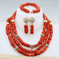 a necklace and earring set with red beads