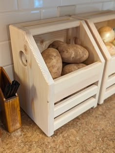 potatoes in wooden crates sitting on a counter