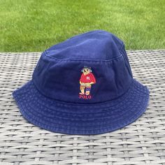 Vintage Navy/White/Beige/Black Polo Bear Bucket Hat Iconic embroidered Fisherman Polo Bear image wearing a cute blue bucket hat 🧸 Diameter of the inside of the hat is roughly 22-24in varying slightly with each hat One size fits all, perfect for festivals, raves or any event where you need to look like a baller Free Shipping Included with every purchase 🚀 No returns on sizing issues Navy Cotton Brimmed Hat, Blue Wide Brim Bucket Hat For Outdoor, Blue Brimmed Bucket Hat For Outdoor, Wide Brim Blue Bucket Hat For Outdoor, Casual Navy Bucket Hat For Outdoor, Casual Navy Bucket Hat For Beach, Navy Casual Bucket Hat For The Beach, Navy Bucket Hat With Curved Brim For Summer, Navy Casual Bucket Hat For Beach