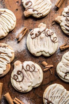 cookies decorated with white icing and cinnamon sticks