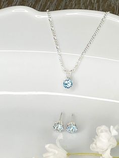 March birthstone, beautiful Aquamarine cubic zirconia necklace and earring set. 4mm or 5mm round light blue stone hand set in 6 prong sterling silver pendant and sterling silver posts. Aquamarine pendant comes on an 18 inch sterling silver figaro chain. 4mm gemstone set is 3/4 carat total weight. 5mm gemstone set is 1 1/3 carat total weight. This Aquamarine necklace and earring set is a perfect gift idea! The set comes on a jewelry card that says: Generous, Dreamer, Honest. This gorgeous necklac December Jewelry, Silver Figaro Chain, March Birthday Gifts, Blue Topaz Jewelry, March Birthday, March Birthstone Jewelry, Blue Topaz Necklace, Zirconia Necklace, Blue Topaz Pendant