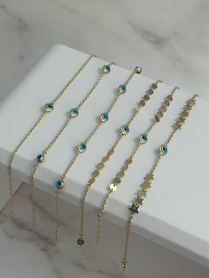 Explore our enchanting 14k Solid Gold Blue Evil Eye Bracelet Collection, where timeless elegance meets protective charm. Each bracelet in this collection features the iconic blue evil eye, a symbol believed to ward off negative energy and bring good fortune. Crafted from luxurious 14k solid gold, these bracelets offer a perfect blend of sophistication and durability P R O D U C T ∙ M E A S U R E M E N T S Bracelet 1: * 100% 14k Solid Gold * Length: Adjustable from 6 to 7 inches  * Weight: 1.6 gr Elegant Blue Chain Bracelet As Gift, Elegant Blue Chain Bracelet For Gift, Blue 14k Gold Tarnish-resistant Jewelry, Tarnish Resistant 14k Gold Blue Jewelry, Adjustable Gold Charm Bracelet In Sterling Silver, 14k Gold Charms Bracelet Fine Jewelry, Gold Chain Bracelet With Extender In Sterling Silver, Blue Gold-plated Tarnish-resistant Jewelry, Blue Tarnish-resistant Gold-plated Jewelry