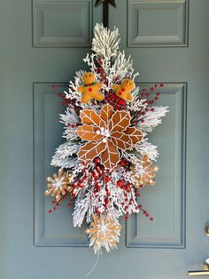 Want to see what it would look like on your door before purchasing? Message me a picture of your empty door and I can show you an example! This beautiful swag will be the perfect touch for your door, double doors, columns, wall, etc. Made with quality faux flocked pine, large gingerbread poinsettia, gingerbread snowflakes, gingerbread bow and girl, flocked branches, red glitter berries, and red crabapples. Hangs easily.  Bow available in many more options! Please note your color choice in the notes section upon checkout (Ex- YES, burlap bow) 30" length shown, available in 30" and 48" Approx 14" wide and 6" deep. If you would like a custom size, color/flower, or have any questions, please message me! All items are packed with care. Looking for a different theme, size or matching items? Mess Gingerbread Poinsettia, Gingerbread Snowflakes, Swag Christmas, Christmas Swag, Door Hanger Wreath, Hanger Wreath, Burlap Bow, Christmas Swags, Burlap Bows