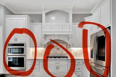 a kitchen with white cabinets and stainless steel appliances in the middle of red letters that spell out go