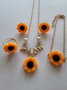 Sunflower earrings with matching necklace, bracelet and ring. Flower Shaped Metal Jewelry For Weddings, Flower Charm Pendant Jewelry For Party, Flower Pendant Jewelry With Flower Charm For Party, Metal Jewelry Gift For Her, Gold Alloy Flower Pendant Jewelry, Metal Clavicle Chain Jewelry Gift For Her, Metal Clavicle Chain Jewelry As Gift For Her, Elegant Yellow Metal Jewelry, Metal Jewelry With Flower Charm And Pendant