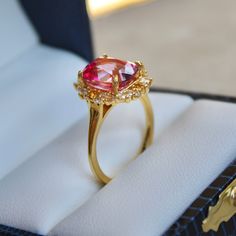 Introducing the Queen of Grace and grandeur, the Poppy Pink Topaz Ring—a true masterpiece in vintage charm. The genuine Pink Topaz center stone is complemented by sparkling citrine and white topaz accents. Its vintage floral design is an ode to classic beauty, with intricate prongs shaped like delicate leaves that cradle the centerpiece. Crafted in luxurious 14k Gold Vermeil, this ring offers a touch of sophistication and a burst of color that will turn heads wherever you go. Gemstones: Elongate Gold Heirloom Ruby Ring With Gemstone Accents, Heirloom Gold Ruby Ring With Gemstone Accents, Heirloom Yellow Gold Gemstones With Accents, Classic Yellow Gold Topaz Ring With Gemstone Accents, Timeless Ruby Ring With Rose Cut Diamonds For Wedding, Heirloom Jewelry With Accent Stones For Proposal, Heirloom Topaz Ring With Rose Cut Diamonds, Heirloom Yellow Gold Topaz Ring With Center Stone, Exquisite Topaz Ring With Center Stone For Anniversary