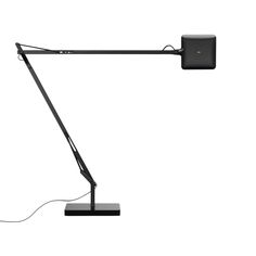 a black desk lamp on a white background with a cord plugged into the base