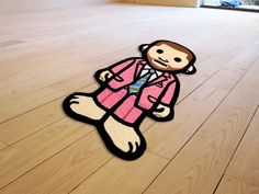 a floor mat with a cartoon monkey on it's side and an image of a man in a pink suit