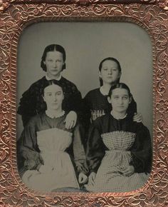 an old black and white photo of three women