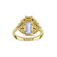 a yellow gold ring with an aqua blue topazte surrounded by white diamond accents