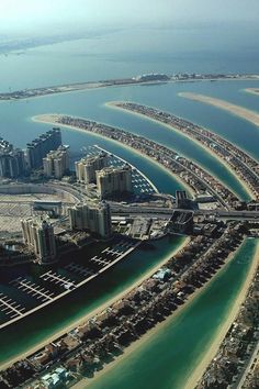 an aerial view of a city with many buildings and water in the middle of it