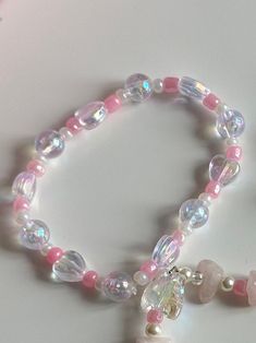 "Beloved"  elastic/stretchy bead bracelet  pink and white faux pearls with iridescent hearts handmade with love ♡  ⋆ ˚｡ ₊* ୨୧*₊ ｡˚⋆ material: plastic, resin ⋆ ˚｡ ₊* ୨୧*₊ ｡˚⋆ CARE: - Excessive pulling may result in breakage, please be gentle - To clean, please gently wipe with a damp cloth or paper towel - These elastic stretch bead bracelets can be submerged under water, but please limit duration and frequency. Let air dry completely before putting away SHIPPING: all packages come tracked, shipp Kawaii Pink Beaded Bracelets, Pink Beaded Kawaii Bracelets, Kawaii Adjustable Pink Beaded Bracelet, Kawaii Pink Beaded Bracelets With Round Beads, Pink Adjustable Kawaii Beaded Bracelets, Adjustable Pink Beaded Bracelets In Kawaii Style, Adjustable Pink Beaded Bracelet In Kawaii Style, Cute Pink Crystal Bracelet With Round Beads, Pink Adjustable Pearl Stretch Bracelet