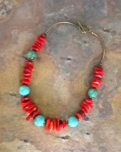 This is a very special turquoise and coral necklace that has an Indian vibe.  The combination of the two colors makes a great statement and will make a wonderful addition to your jewelry collection. The red coral beads are so pretty with the blue turquoise howlite and it has brass accents and a brass toggle closure. This turquoise and coral necklace will get complements when you choose to wear it. It is a special turquoise and coral statement piece that will always be noticed for the vibrant col Handmade Artisan Red Coral Beaded Necklaces, Bohemian Hand-strung Red Coral Necklaces, Adjustable Bohemian Red Coral Necklace, Southwestern Red Jewelry With Natural Stones, Unique Hand-strung Red Jewelry, Unique Red Hand-strung Jewelry, Bohemian Red Turquoise Single Strand Necklace, Artisan Red Coral Hand-strung Jewelry, Artisan Hand-strung Red Coral Jewelry