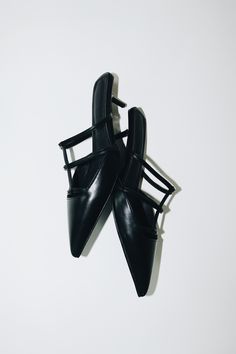 Salma features a pointed toe, low kitten heel, and a strappy upper in a matte black vegan leather. The perfect mules. Size and Fit Information: U.S. Sizing Available in whole and half sizes Runs true to size (Note: Not using leather and other materials from animals significantly reduces environmental impact, however, we acknowledge that synthetic alternatives are not without environmental concerns. As we grow, we are dedicated to finding alternative materials that are even safer for the planet.) Composition: 1.5"/40 mm heel Sole: Rubber 100% Vegan, Animal and Cruelty-Free Imported Black Single Toe Strap Kitten Heels For Spring, Black Kitten Heels With Single Toe Strap For Spring, Chic Black Kitten Heels With Single Toe Strap, Black Kitten Heels With Heel Loop For Spring, Black Pointed Toe Mules With Heel Loop, Black Kitten Heels With Single Toe Strap For Evening, Sleek Pointed Toe Mules With Heel Loop, Sleek Low Heel Kitten Heels For Night Out, Sleek Kitten Heels For Night Out