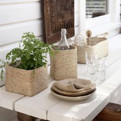 the table is decorated with baskets and plants