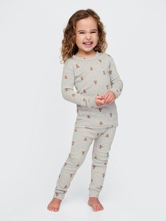 Soft cotton pajama top and pants set with a cozy brushed interior.  Crewneck.  Long sleeves.  Certain styles have embroidered Brannan Bear at chest.  Elasticized waist at PJ pants.  Assorted allover Holiday-themed prints.  Made with 100% organically grown cotton, which is grown without the use of synthetic pesticides and fertilizers.  This product was made in a factory that runs the Gap Inc.  P. A. C. E.  Personal Advancement & Career Enhancement) program.  P. A. C. E.  is our educational progra Soft Cotton Pajamas, Toddler Pajamas, Brand Collaboration, Top And Pants Set, Support People, Pj Pants, Cotton Pyjamas, Pajama Top, Pesticides