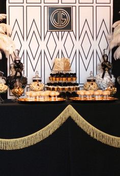 a black and gold themed dessert table