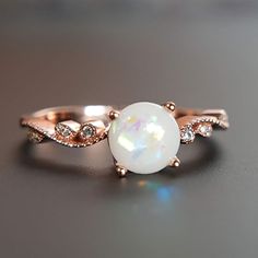 Beautiful handmade item! Here, on Etsy made as simulation only-just resin and white color.  Breastmilk Ring made with white gold plated sterling silver or plated with rose or yellow gold. Opal effect breastmik 7mm rounded shaped stone. Any size available. Rose gold,  or white gold plated options.  Pearl powder or opal effect can be added to this fine breastmilk ring. Beautiful inlaid cubic zirconia surround and accentuate your breastmilk stone while a skin-friendly 925 sterling silver ring core. White Opal Birthstone Crystal Ring, White Opal Crystal Ring For Gift, Rose Gold Moonstone Jewelry With Birthstone, Elegant Rose Gold Moonstone Jewelry, Round White 14k Rose Gold Jewelry, 14k Rose Gold Round Diamond White Jewelry, Adjustable Rose Gold Opal Jewelry, Sterling Silver Rose Gold Crystal Ring, Rose Gold Sterling Silver Crystal Ring