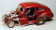 a red toy car with the hood open