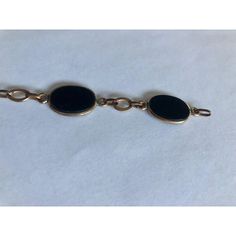 This is part of Chairish’s Fine Jewelry assortment.  This gorgeous 1950s 12K Gold Oval Onyx Link Bracelet has five smooth-sided black onyx stones wrapped in 12K gold and separately by matching chain links. Simply elegant and ready to wear, this link bracelet, which appears to have the Coro mark (illegible), will be a fabulous addition worn alone or stacked with other complementary bracelets for maximum impact.  Dimensions: 7.5" L Condition: Good vintage condition; wear consistent with age. Please see pics for details. Marks: 12KT, Coro(?) Elegant Black Link Jewelry, Classic Black Link Jewelry, Black Link Jewelry For Formal Occasions, Formal Onyx Oval Cabochon Jewelry, Antique Oval Link Bracelet For Formal Occasions, Vintage Black Enamel Bracelets For Formal Occasion, Black 14k Gold Bracelet For Formal Occasions, Formal Black Enamel Metal Bracelets, Timeless Oval Black Enamel Jewelry