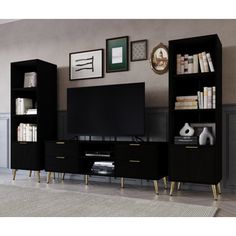 an entertainment center with bookshelves, television and pictures on the wall