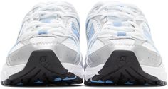 Low-top mesh sneakers in white. Faux-leather overlays in blue, white, and reflective silver-tone throughout. Round toe. Tonal lace-up closure. Logo printed in white at padded tongue. Padded collar. Rubberized logo appliqué in blue and silver-tone at sides. Grosgrain pull-loop in blue at heel collar. Rubberized logo appliqué in silver-tone at ABZORB® foam rubber midsole in blue and white. Treaded rubber outsole in black, white, and blue. Tonal hardware.Supplier color: White/Light blue New Balance Clothing, New Balance For Men, New Balance For Women, New Balance Outfit, New Balance White, Mesh Sneakers, Luxury Streetwear, Air Jordan Sneaker, Blue And Silver