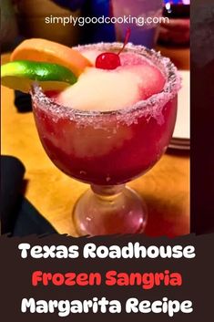 a frozen sangria margarita in a glass with a lime slice on the rim and text that reads, texas roadhouse frozen sangria margarita recipe