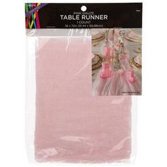 a pink table runner in plastic packaging