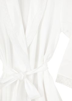 Embracing a European aesthetic of hand embroidery with elegant touches of cotton lace, Jacaranda Living produces a wide variety of high quality luxury linens—for bath, table, sleepwear, and more that feel as good as they look in your home or wardrobe. Swaddle yourself in comfort with the Long Sleeve Cotton Bathrobe with Lace Detail, featuring French lace on the cuffs and a delightfully warming shawl collar. As nice for just out of the bath as it is for some old fashioned lounging. This robe can Elegant Cotton Sleepwear For Spring, Elegant White Cotton Sleepwear, Elegant Cotton Sleepwear For Summer, Elegant Cotton Summer Sleepwear, White Cotton Sleepwear With Floral Embroidery, Elegant Cotton Robe For Daywear, Elegant Summer Cotton Sleepwear, Elegant Cotton Daywear Robe, Elegant Summer Robe With Lace Trim