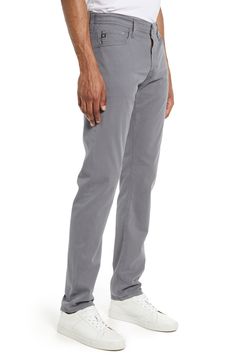 Made from stretchy Italian sateen with a microsuede finish, these slim-cut pants are your go-to from work to weekend and everywhere in between. 14" leg opening; 9 1/2" front rise; 14 1/2" back rise Zip fly with button closure Five-pocket style 97% cotton, 3% elastane Machine wash, tumble dry Imported Slim Fit Pants For Business Casual, Slim Fit Straight Pants, Modern Straight Stretch Bottoms, Modern Stretch Straight Bottoms, Modern Slim Fit Straight Leg Pants, Modern Straight Fit Mid-rise Pants, Slim Fit Pants Men, Fitting Pants, Ag Jeans