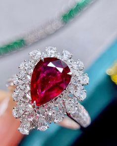 Bienvenue chez Odyssée Joaillerie, nous nous spécialisons dans le diamant coloré,  et les bagues de fiançailles. Nous offrons un grand choix: blanc, ou jaune, ou rose, platine,  nos bijoux sont finement fabriqués pour une qualité exceptionnelle! Symbole d'amour par excellence, le diamant est une belle preuve d'amour. Le joyau de vos rêves est le vôtre! Détails : Marque: Odyssée Joaillerie Métal : or blanc 18k  * Pierre centrale : Rubis naturel 2,03ct * Pierres latérales: Diamants incolore 1,16ct Fine Jewelry Pear-shaped Ruby Ring With Diamond, Pear-shaped Ruby Ring With Diamond, Diamond Ruby Ring With Prong Setting In Pear Shape, Red Pear-shaped Ruby Ring With Brilliant Cut, Red Ruby Ring With Brilliant Pear-shaped Cut, Red Pear-shaped Ruby Ring, Fine Jewelry Teardrop Ruby Ring With Diamond, Teardrop Ruby Ring In Fine Jewelry Style, Teardrop Ruby Ring With Diamond In Fine Jewelry Style