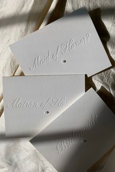 three white cards with the words maid of honor written on them