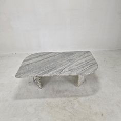 a marble coffee table sitting on top of a white floor