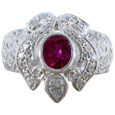 A beautiful platinum ring featuring a vivid red oval shaped ruby, weighing 0.92 carats, which we believe to have a Burmese origin. A larger pear shape diamond along with rounds accent the center stone, set in platinum with milgrain settings. Size 6 3/4 Diamond Ring Platinum, Ruby Diamond Ring, Ruby Diamond Rings, Platinum Diamond Rings, Jewelry Rings Diamond, Platinum Ring, Pear Shaped Diamond, Ruby Diamond, Burmese