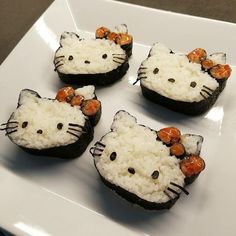 four hello kitty rice cakes on a white plate