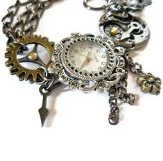 This beautiful steampunk watch bracelet is a unique art piece for the purveyor of eclectic and  sophisticated hand-crafted artisan jewelry. Steampunk is a unique style that combines the  Victorian look with a cog and steam powered industrial revolution look. The effect is certainly  unique and eye-catching.  Gears, cogs, watch parts and Swarovski crystals make this chunky bracelet a wondrous thing.  Surrealism meets realism in this esoteric world of tech. Steampunk jewelry is an impressive  phen Steampunk Style Bracelet Jewelry Gift, Steampunk Silver Bracelet As Gift, Silver Steampunk Bracelet For Gift, Silver Steampunk Bracelet As Gift, Steampunk Metal Bracelet, Steampunk Metal Bracelet Jewelry, Steampunk Jewelry With Vintage Charm, Steampunk Watch, Watch Jewelry