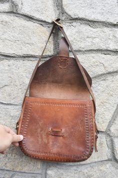 "Vintage Leather Handbag, Genuine Leather Bag, Vintage Leather Case, Leather Handbag, Brown Bag, Handmade Bag, Shoulder Bag, Old Leather Bag Description: A traditional genuine leather bag in the 1960s. It consists of 1 main compartment (photo №10). The bag has an adjustable strap, decorations made of brass with brass buckle, partially covered with patina (greenish hue). Used! Long-term use! The bag has many years of use. Note: Please check photo №7 and №8 before ordering this item. Dimensions: 9 Handmade Saddle Shoulder Bag For Travel, Vintage Pouch Saddle Bag For Daily Use, Vintage Saddle Bag Pouch For Daily Use, Old Leather Bag, Vintage Leather Handbag, Brown Bag, Handmade Bag, Genuine Leather Bags, Wooden Dolls