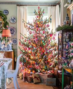 a brightly colored christmas tree in a living room