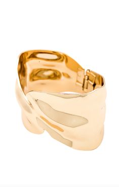 The Abstract Textured Cuff Bracelet in Gold is a must-have for the modern woman who exudes elegance and grace. Crafted with a touch of magic, these bracelets effortlessly elevate any outfit, adding a golden glow to your wrist. Embrace your inner goddess and shine with confidence. And layer it up. These bracelets were made for it. 18k gold-plated steel Hinge closure Textured effect Measures approx 2.4" in diameter Steel base: Provides durability and strength Timeless Gold Metal Cuff Bracelet, Elegant Cuff Bracelet Jewelry, Gold Plated Yellow Gold Cuff Bracelet, Yellow Gold Plated Cuff Bracelet, Luxury Cuff Bangle For Evening, Luxury Evening Cuff Bangle, Elegant Jubilee Bracelet Cuff Jewelry, Luxury Evening Jewelry With Oyster Bracelet, Chic Gold Bracelets With Oyster Detail