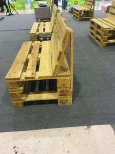 several wooden benches made out of pallets on display