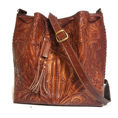 Leather Bag For Women. Featuring a gorgeous chiseled design, this rustic Tooled Leather Purse will help you bring a little vintage flair to your everyday outfit. The perfect size for fitting all of your everyday essentials, this purse was actually handmade with love and care by talented Mexican artisans , giving it a rustic touch that's hard to find in stores.  💮 Measures : height:29 cm.  11.2 inches width : 28cm.  11 inches base:13 cm. 5 inches detachable adjustable large strap: 43inches  110 Vintage Leather Shoulder Bag With Engraved Details, Vintage Engraved Leather Shoulder Bag, Vintage Leather Shoulder Bag With Engraving, Vintage Engraved Bags For Everyday Use, Brown Embossed Shoulder Bag For Everyday, Leather Bag With Engraved Details For Everyday Use, Leather Shoulder Bag Engraved For Everyday Use, Leather Bag With Engraving For Everyday Use, Engraved Leather Shoulder Bag For Everyday