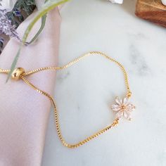 "Our Adjustable Flower Bracelet features delicate plumeria charms on a gold chain, perfect for bridal parties and plant lovers alike. This dainty Hawaiian bracelet is not only a charming gift for bridesmaids but also a lovely accessory for anyone who adores floral-inspired jewelry.  Materials : ------------- - glass crystal flower - gold plated chain with adjustable sliding clasps for easy on and off Dimension: ---------------- Flower Charm: 0.75 inch bracelet size : slides open up to 8 inch 🌸 For other plumeria jewelry, click here : https://www.etsy.com/shop/YsmDesigns?ref=seller-platform-mcnav&search_query=plumeria 🌸 For other bracelets, click here : https://www.etsy.com/shop/YsmDesigns?ref=seller-platform-mcnav&search_query=bracelet 🌸 For all floral jewelry, click here : https://www. Gold Flower-shaped Bracelets For Party, Gold Adjustable Chain Bracelet For Weddings, Rose Gold Flower Shaped Bracelets For Wedding, Gold Wedding Bracelet With Adjustable Chain, Delicate Adjustable Gold Charm Bracelet, Gold Feminine Bracelets For Wedding, Feminine Gold Bracelets For Gift, Feminine Gold Bracelet For Gift, Gold Dainty Charm Bracelet For Bridesmaid Gift