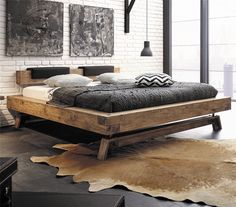 a bed sitting on top of a wooden frame