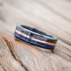 a wedding band that has been made to look like it is on top of a wooden table