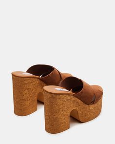 Step up your shoe game with our SAFFRON sandal. Featuring a cork bottom and platform for extra lift, a comfortable block heel, and stylish criss-cross straps, these mules will elevate any outfit. 4.75 inch heel height 1.75 inch platform Suede upper material Unlined Synthetic sock Synthetic sole Imported Platform Mules, Chunky Sandals, Cross Straps, Shoe Game, Chestnut, Step Up, Criss Cross, Block Heels, Cork