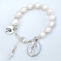 Beautiful and meaningful girl's confirmation bracelet comes with your choice of saint medal along with a hand stamped, sterling silver initial disk stamped with 1 letter. (If you don't see your saint, please inquire as I might have it!) **Since all of the saint medals look different, to see what yours looks like please search for the saint within my shop. I have most of them listed as necklaces.** > 8mm Swarovski white crystal pearls represent the Hail Mary prayers. > 10mm pearl represents Adjustable Rosary Bracelet With Miraculous Medal For First Communion, Personalized White Bracelets For Confirmation, Personalized White Bracelet For Confirmation, Personalized Spiritual Bracelets For First Communion, White Jewelry For Confirmation On Mother's Day, Classic Adjustable Jewelry For First Communion, White Engraved Round Bracelets, Personalized Silver Rosary Bracelet For Mother's Day, Personalized Adjustable Rosary Bracelet For Confirmation