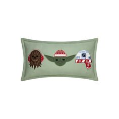 a green rectangular pillow with star wars characters on the front and sides, along with a red knitted headband