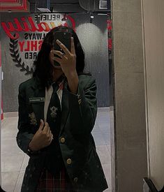 a woman taking a selfie in front of a mirror