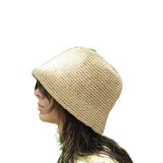 This hat is handmade and crafted from raffia yarn. Raffia yarn is a natural and durable material, ensuring the hat's longevity. The beige color and simple design make it an ideal accessory for both everyday use and outdoor activities like the beach. The wide-brim bucket shape provides sun protection and offers a stylish look. Its comfortable and lightweight structure ensures easy and prolonged wear. Raffia. You can store this hat, knitted from raffia rope, in a breathable cloth bag, protect it from fire and heat, and wipe the stains with a clean damp cloth. Eco-friendly Toquilla Straw Hat, Natural Wide Brim Toquilla Straw Bucket Hat, Handwoven Beige Brimmed Bucket Hat, Beige Toquilla Straw Bucket Hat With Flat Brim, Natural Handwoven Bucket Hat With Curved Brim, Beige Wide Brim Handwoven Bucket Hat, Beige Handwoven Wide Brim Bucket Hat, Braided Flat Brim Panama Hat In Natural Color, Beige Woven Panama Hat With Curved Brim